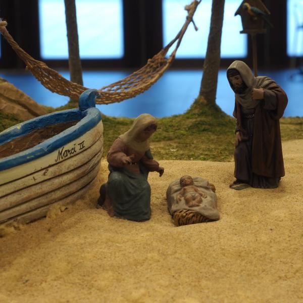 María y José con el niño junto a una barca